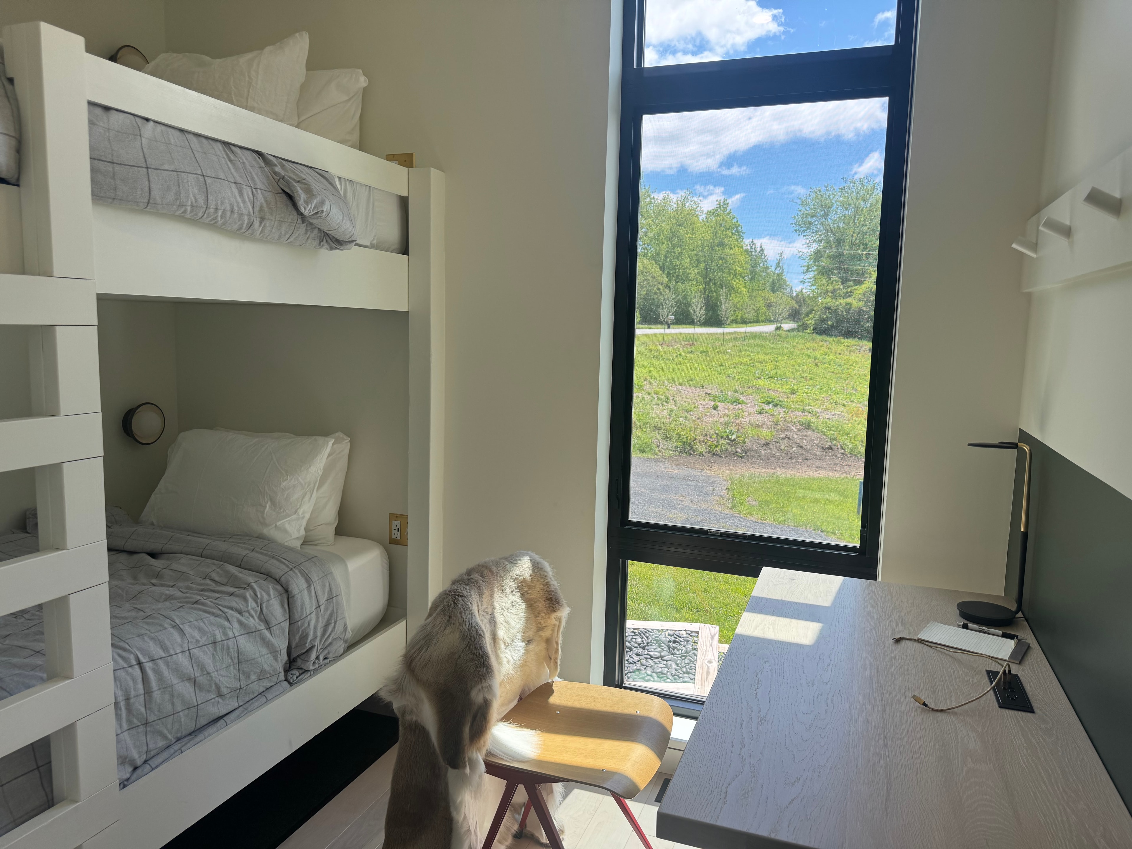 Second bedroom with built-in bunk beds, floor-to-ceiling window, and a desk with lake views